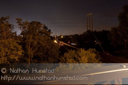 A bottle rocket soars into the sky while a train passes through